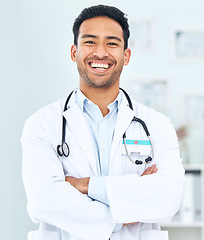 Image showing Portrait of doctor with smile, arms crossed and healthcare, professional in hospital for support and help. Medicine, happy man with confidence and pride in medical career, expert surgeon in clinic.