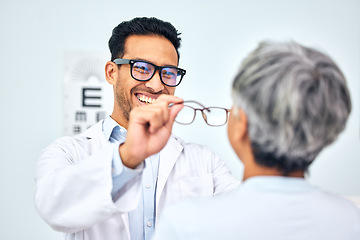 Image showing Glasses, optometrist and client with appointment, vision and consultation with diagnosis, smile and help. Office, employee and senior woman with eyewear, doctor and healthcare with wellness and frame