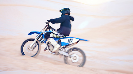 Image showing Dirt, motorbike and athlete with speed in sports, adventure and driving on desert, sand dune and outdoor riding in nature. Extreme sport, bike or motorcycle drive with helmet, gear or man in action