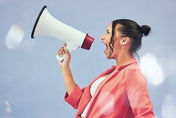 Image showing Megaphone, protest or motivation with a woman shouting on a blue background in studio for politics. Noise, change and a young speaker screaming into a bullhorn for leadership, justice or freedom