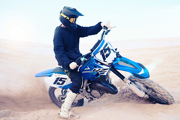 Image showing Dirt, motorbike and athlete driving in sports, adventure or man in desert, sand and riding outdoor on dune in nature. Extreme sport, bike or motorcycle drive with helmet, gear or person with freedom