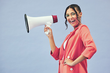 Image showing Portrait, megaphone and woman with a smile, announcement and speech on a blue studio background. Face, person or model with a gender equality, communication and bullhorn with news, noise and speaking