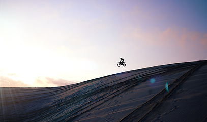 Image showing Motorcycle, person and jump for training or sports with fitness, balance or challenge in nature on mock up space and sky. Bike, freedom and adventure for competition, exercise or talent in desert