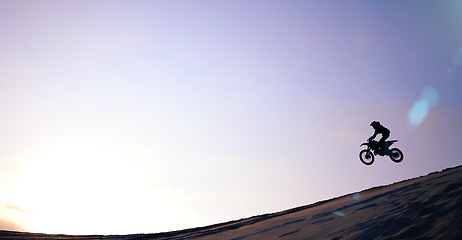 Image showing Motorcycle, person and jump for fitness or sports with training, balance or challenge in nature on mock up space and sky. Bike, freedom and adventure for competition, exercise or talent in desert