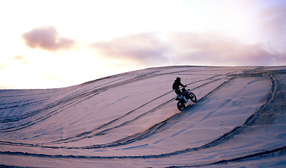 Image showing Sand, desert or athlete with motorcycle for action, adventure or fitness with performance for adrenaline. Sunset, sports or person on motorbike on dunes for training, exercise or race or challenge