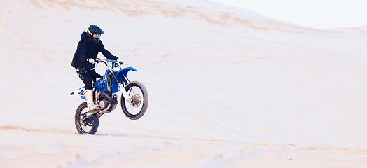 Image showing Freedom, desert or athlete driving motorcycle for action, adventure or fitness with performance or adrenaline. Sand, sports or person on motorbike on dunes for training, exercise or race or challenge