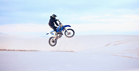 Image showing Desert, jump or person driving motorcycle for action, adventure or fitness with performance or adrenaline. Sand, risk or sports athlete on motorbike on dunes for training, exercise or race challenge