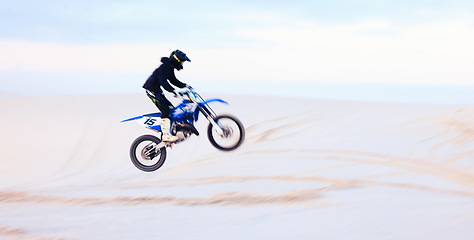 Image showing Sand, jump or athlete driving motorcycle for fitness, adventure or action with performance or adrenaline. Desert, risk or sports person on motorbike on dunes for training, exercise or race challenge