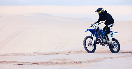 Image showing Sand, speed or athlete driving motorbike for action, adventure or fitness with performance or adrenaline. Fast, nature or sports person on motorcycle on dunes for training, exercise or race challenge