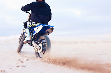 Image showing Desert, dust or driver driving motorcycle for action, adventure or fitness with performance or adrenaline. Sand, back or sports athlete on motorbike on dunes for training, exercise or race challenge