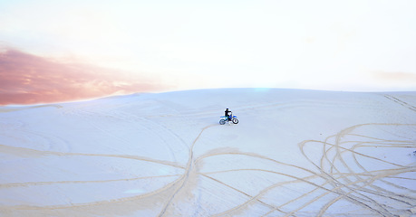 Image showing Nature, sand or athlete driving motorbike for action, adventure or fitness with wellness or adrenaline. Workout, hill or sports driver on motorcycle on dunes in training, exercise or race challenge