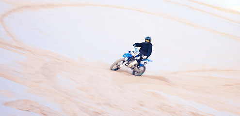 Image showing Action, desert and a person on a bike for cycling, extreme sport and adrenaline on a vacation. Sand, competition and a bike or racer for travel, training or adventure for performance on a motorbike
