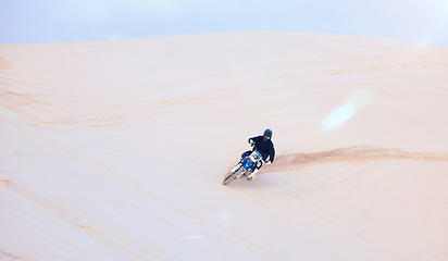 Image showing Fast, sand or driver driving motorbike for action, adventure or fitness with performance or adrenaline. Nature, dirt or sports athlete on motorcycle on dunes in training, exercise or race challenge