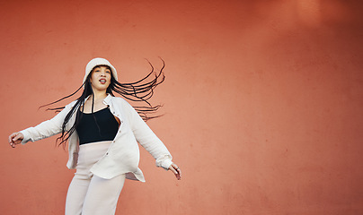 Image showing Fashion, space and an urban woman on a red background for freedom, energy or unique street style. Wall, mock up and hip hop with a young gen z person on a color backdrop for marketing or advertising