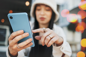 Image showing Hands, travel and woman with phone at a cafe for social media, texting or chatting in a city. Smartphone, app and lady influencer at coffee shop for content creation, podcast or traveling blog post