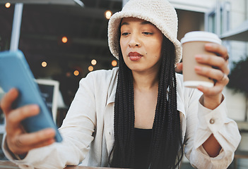 Image showing Phone, networking and woman with a coffee in the city typing a message on the internet. Technology, latte and female person scroll on social media or mobile app with cellphone at restaurant in town.