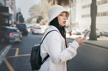 Image showing Woman on street with phone, taxi app and travel holiday with streetwear, waiting and online location. Influencer, blogger or gen z girl with urban fashion, smartphone and cab transport in city road