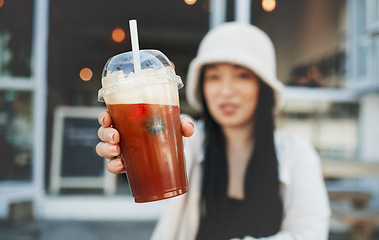 Image showing Woman hand, smoothie and closeup outdoor at a restaurant and drink from cafe. Milkshake, coffee shop and gen z fashion of a female person with a straw on break on diner patio with blurred background