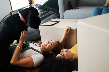 Image showing Moving, boxes and couple with a dog in home, living room or women relax together on floor bonding with puppy or pet. New house, happiness or people with love for animal and investment in property