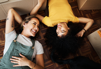 Image showing Top view, lesbian and couple with boxes, homeowners and achievement with love, bonding and property. Queer people, lgbtq or happy women on the ground, new apartment and conversation with real estate