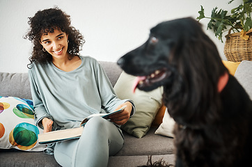 Image showing Reading a book, dog and a woman on home sofa to relax with animal in a living room. Pet owner, happiness and a young person on a couch with love, care and wellness or friendship in a cozy apartment