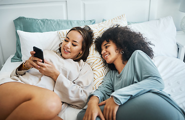 Image showing Phone, social media and a lesbian couple in bed together in the morning for communication or to relax. Love, lgbt and a woman watching a movie or video with her girlfriend in the home bedroom