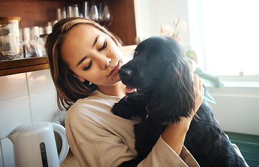 Image showing Love, hug and woman with a dog in home kitchen to relax and play with animal. Pet owner, happiness and asian person playing with companion, care and wellness or friendship in cozy apartment