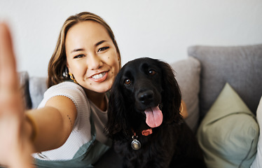 Image showing Love, selfie and woman with dog on home sofa to relax and play with animal. Pet owner, care and asian person influencer with companion, smile and friendship or social media profile picture and memory