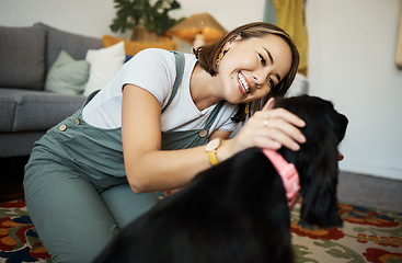 Image showing Love, smile and woman with dog in home lounge to relax and play with animal. Pet owner, happy and asian person on floor with companion, care and wellness or friendship and together in cozy apartment