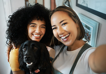 Image showing Happy, selfie and portrait of lesbian couple with dog in modern apartment bonding together. Love, smile and interracial young lgbtq women taking a picture and holding animal pet puppy at home.