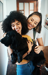 Image showing Happy, smile and lesbian couple holding dog in modern apartment for bonding together. Love, family and interracial young lgbtq women hugging and embracing their sweet animal pet puppy at home.