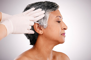 Image showing Anti aging, gloves and senior woman with needle, beauty and skincare on a white studio background. Hands, mature person and model with plastic surgery, cosmetics or healthcare with wellness or filler