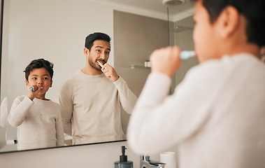 Image showing Dad, boy and child brushing teeth in mirror for hygiene, morning routine and teaching healthy oral habits at home. Father, kid and dental cleaning in bathroom with toothbrush, fresh breath and care
