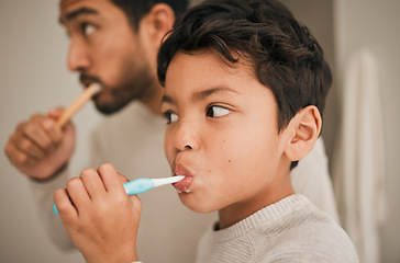 Image showing Face, boy and child brushing teeth with father for hygiene, morning routine or development of healthy oral care at home. Kid, dad and toothbrush for dental cleaning, fresh breath or mouth in bathroom