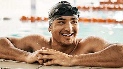 Image showing Happy, man and athlete relax in swimming pool after training, workout or exercise for wellness or cardio fitness in gym. Swimmer, smile and enjoy sports challenge or summer water polo competition