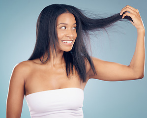 Image showing Hair care, texture and happy woman with split ends in studio or blue background for salon keratin treatment. Beauty, growth or female model smiling with hairstyle damage, collagen or cosmetic problem