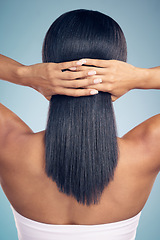 Image showing Beauty, hair and hands with a woman from the back in studio on a gray background for shampoo treatment. Keratin, spa or salon for haircare and a model closeup with natural and aesthetic growth