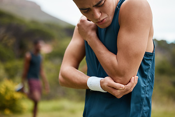 Image showing Sports man, nature and elbow pain from workout training injury or fitness running accident outdoors. Bad bruise, broken arm bone or closeup of injured athlete runner with exercise emergency in park