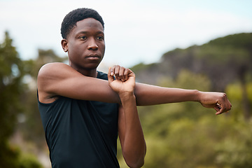 Image showing Fitness, stretching and exercise with man outdoor for health and wellness. Serious runner, athlete or african sports person in nature to start morning run, workout or training with arm muscle warm up