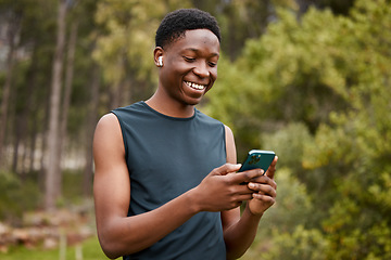 Image showing Phone, earphones and a man outdoor for fitness and listening to music. Happy runner, athlete or african sports person in nature to start exercise, workout or training and streaming radio online