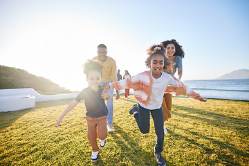 Image showing Nature, excited and family running, have fun and playing games, parents chase children and bond on summer travel vacation. Energy, sunshine and happy kids, mom and dad love, care and freedom together