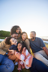 Image showing Family, laughing and outdoor with fun together with parents, kids and grandparents on holiday. Vacation, hug and happy mother, dad and young children with funny joke and game on grass with bonding