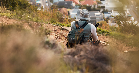 Image showing Back, relax and view with a man hiking on mountain terrain for travel, freedom or adventure in a remote location. Hike, rest and scenic with a backpacker or hiker outdoor in nature to explore