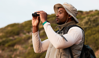 Image showing Hiking, binocular or black man on mountain in nature on trekking journey or adventure for freedom. View, holiday vacation or African hiker walking to search in park for exercise, fitness or wellness