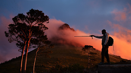 Image showing Goal, pointing and a man hiking in the mountains at night for travel, freedom or to explore remote nature. Sky, motivation and dark with a backpacker trekking in the forest for adventure on space