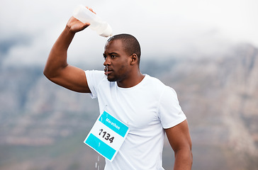 Image showing Marathon, pour water or tired runner running on road for exercise, fitness training or outdoor workout. Sports race, black man or exhausted athlete on street with endurance or fatigue in challenge