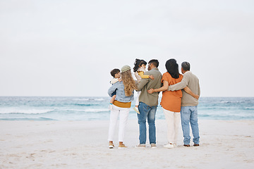 Image showing Parents, grandparents and children at beach outdoor for hug, support and love in nature. Back of men and women or big family with kids on holiday, adventure or vacation at sea for banner space in sky