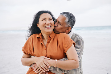 Image showing Beach, hug and senior happy couple kiss, support and care on travel holiday, retirement vacation and affection in nature. Embrace, freedom and romantic elderly man, old woman or marriage people bond