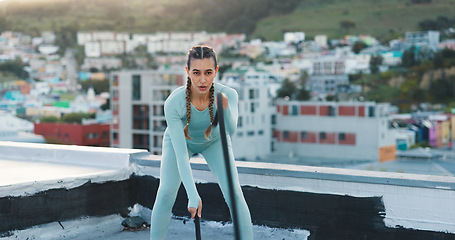 Image showing Rope, fitness and woman training in city on rooftop for health, workout and body performance. Outdoor, strong and tired girl breathing, exercise or cardio with equipment, challenge and endurance