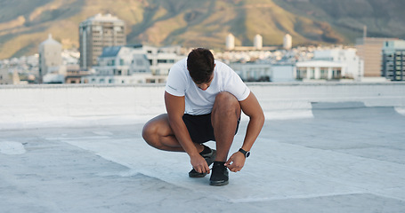 Image showing City, fitness man and tie shoes lace, sneakers and start exercise, morning training or workout challenge. Rooftop footwear, wellness and outdoor athlete or person prepare for sports, health or cardio